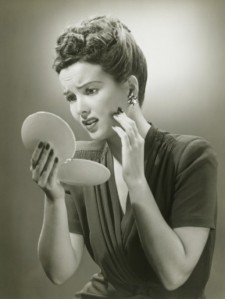 woman-looking-in-mirror-vintage
